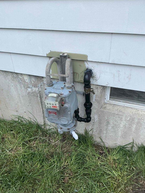 Completed installation of a 10kW residential standby generator with integrated Kohler transfer switch and new 100-amp electrical panel. Mounted transfer switch and metering equipment on exterior wall with proper conduit routing and weather-tight connections. Installed gas supply line with shutoff valve and connected to existing natural gas system. All electrical components secured to building exterior with appropriate hardware, conduit straps, and junction boxes per code requirements. System tested and operational upon completion.