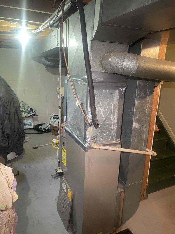 Conducted comprehensive full system estimate for residential HVAC replacement in basement utility area. Evaluated existing 31-year-old original equipment including furnace and air conditioning system that has experienced recurring operational issues requiring multiple repairs over recent years. Assessed current installation configuration, ductwork connections, electrical supply, refrigerant line routing, and available space for new equipment replacement to provide complete system upgrade recommendations.