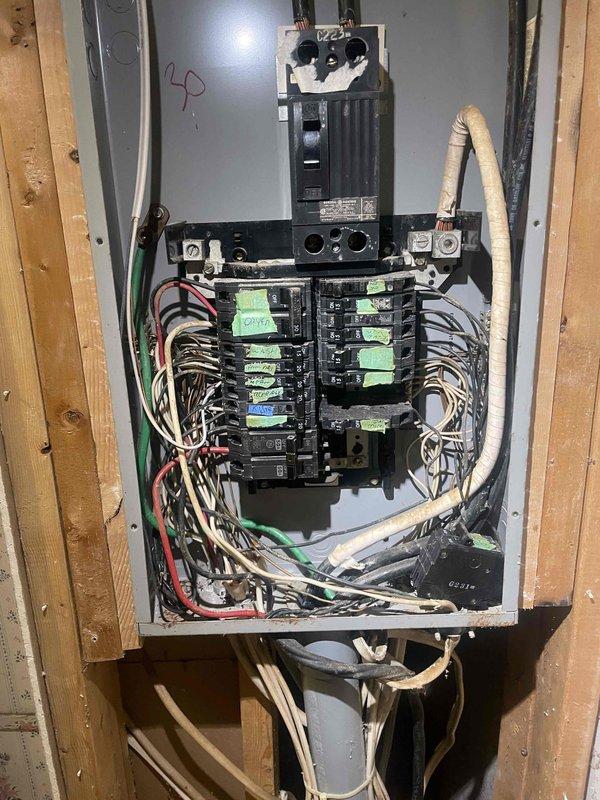 Conducted comprehensive full system estimate for aged residential property currently equipped with furnace only and no existing air conditioning. Evaluated existing electrical panel capacity and circuit availability to support new HVAC system installation, documenting current breaker configuration and available amperage for equipment requirements. Assessed mechanical space containing aged HVAC equipment, noting accumulated debris and deteriorated conditions in utility area that will require preparation for new system installation. Provided estimate for complete heating and cooling system replacement to add air conditioning capability to residence within current season timeframe.