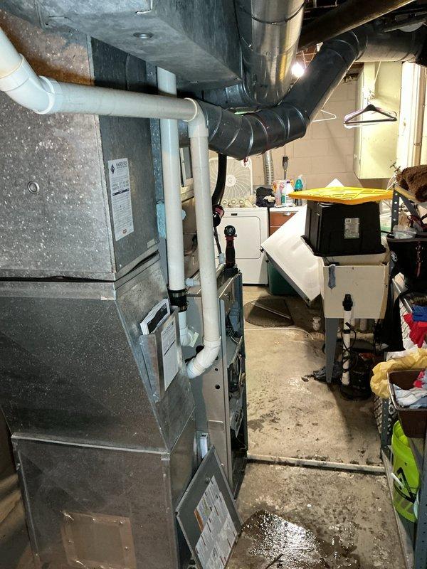 Responded to service call for 13-year-old furnace located in basement. Performed diagnostic inspection of unit, accessing internal components including blower motor assembly, control boards, gas valve connections, and electrical wiring systems. Conducted visual examination of all mechanical components, verified proper connections, and assessed overall system condition. Documented equipment configuration and current operational status with detailed photographs of furnace cabinet, internal components, PVC venting, and surrounding mechanical systems.