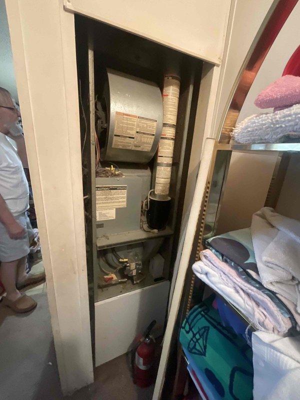 Conducted furnace replacement estimate for a 26-year-old non-operational natural gas heating system located in a utility room behind the kitchen. Assessed existing vertically-oriented air handler with connected ductwork, evaluated electrical panel capacity and circuit protection for furnace replacement compatibility, and documented equipment specifications and installation space constraints. Prepared physical estimate documentation for customer review.