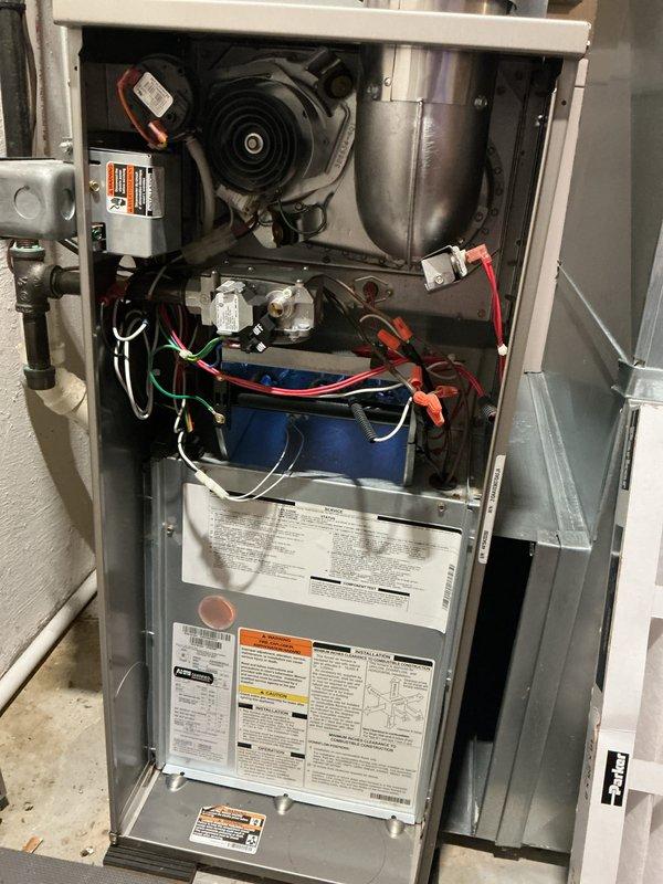 Completed comprehensive AHC maintenance inspection on residential furnace unit. Removed access panels to perform visual inspection of all internal components including blower motor assembly, draft inducer housing, gas valve assembly, electrical connections, and capacitor. Verified proper wire routing and connections throughout compartment, documented equipment condition with photographs, and confirmed all safety labels and technical specifications were legible and intact.