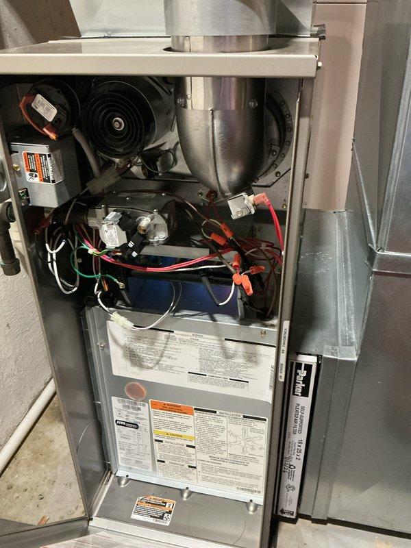 Completed comprehensive AHC maintenance inspection on residential furnace unit. Removed access panels to perform visual inspection of all internal components including blower motor assembly, draft inducer housing, gas valve assembly, electrical connections, and capacitor. Verified proper wire routing and connections throughout compartment, documented equipment condition with photographs, and confirmed all safety labels and technical specifications were legible and intact.