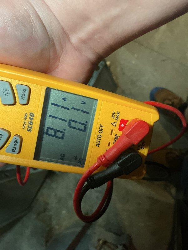 Completed annual cooling maintenance on HVAC system. Performed comprehensive inspection of furnace unit with access panel removed to evaluate internal components including blower motor assembly, electrical connections, and control board. Verified proper electrical readings using digital multimeter, measuring 67.9 on system diagnostics. Inspected all wire connections including orange, blue, green, white, and red conductor pathways for secure terminations and signs of wear. Evaluated control board functionality and verified all safety labels present and legible. System operational and ready for cooling season.