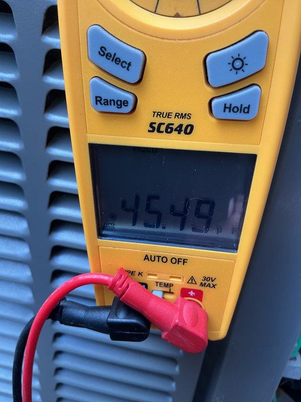 Completed annual cooling maintenance on air conditioning system. Replaced air filter and evaporator pad, performed electrical diagnostics using digital clamp meter with readings indicating normal operating parameters at 45.48 units, and documented system condition through photographic records.