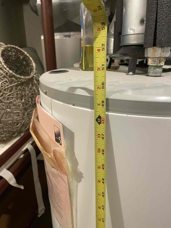 Conducted on-site assessment of non-functional natural gas water heater located in basement with active water leak from bottom of tank. Performed measurements and photographic documentation of existing 20+ year old unit, including height, diameter, and surrounding plumbing connections consisting of copper supply lines, PVC venting, and gas line configurations. Provided comprehensive replacement estimate based on current equipment failure and existing installation parameters.