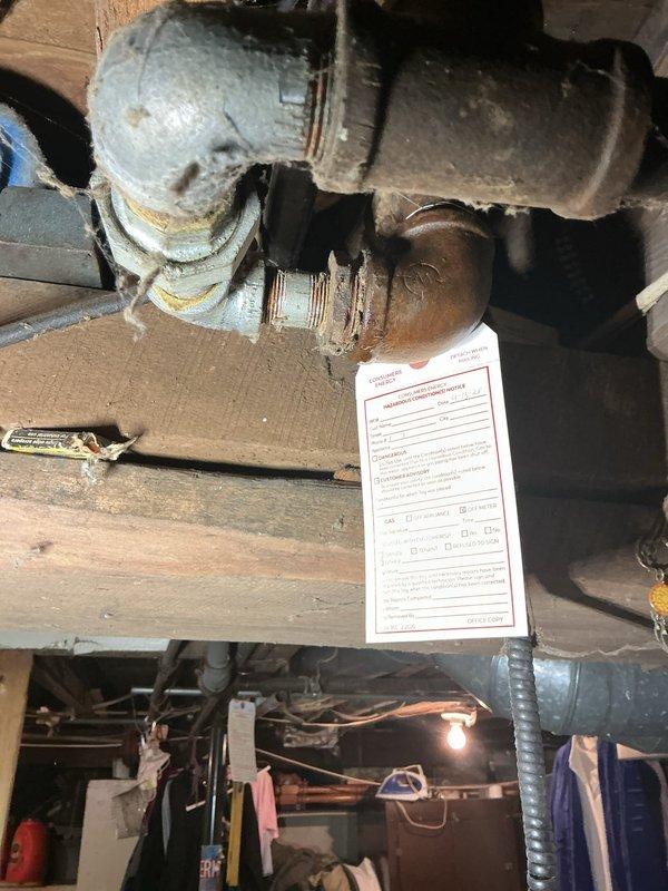 Responded to emergency service call for furnace and hot water tank tagged by gas utility due to gas leak with service disconnected to home. Upon inspection, found severely corroded gas piping system in basement with extensive rust, deterioration, and compromised threaded connections on very old equipment. Documented unsafe conditions including heavy corrosion on gas lines, mold growth on HVAC components, and overall system degradation indicating prolonged moisture exposure and end-of-life equipment status requiring immediate attention before gas service restoration.
