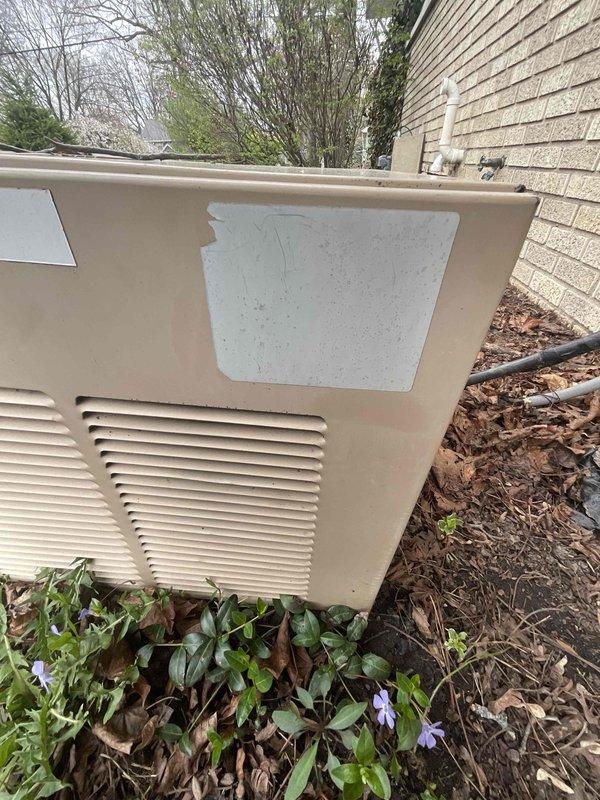 Conducted on-site evaluation for complete air conditioning system replacement. Assessed existing outdoor condensing unit with tan metal casing and horizontal louver vents, noting unit age could not be determined from available documentation or nameplate information. Photographed outdoor equipment positioned on ground-level pad adjacent to residence with beige brick siding for documentation and sizing purposes.

Inspected interior mechanical space to evaluate electrical service capacity and existing infrastructure. Documented electrical panel configuration, circuit breaker arrangement, and available amperage for new equipment installation requirements. Assessed wire routing pathways and identified necessary electrical upgrades to support replacement system. Evaluated utility space layout including ceiling clearances with exposed insulation and framing, floor space availability, and accessibility for equipment installation. Noted copper plumbing components and existing conduit runs that 