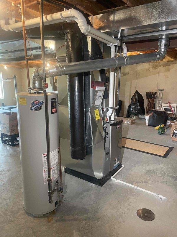 Conducted plumbing estimate for standard natural draft water heater replacement in residential property. Evaluated existing aged water heater installation in basement utility room alongside previously installed HVAC system. Customer requested estimate for standard tank-style water heater replacement to replace aging unit that is still operational but nearing end of service life.
