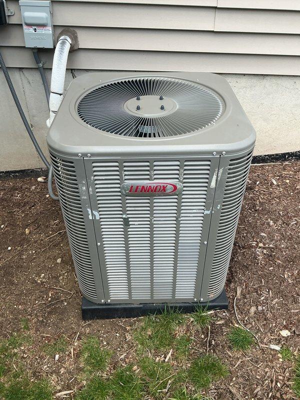 Completed annual cooling maintenance on two Lennox outdoor condenser units. Performed comprehensive inspection of both systems, documenting equipment condition with photographs showing units properly positioned on isolation pads with adequate clearance. Verified refrigerant lines, electrical disconnects, and exterior cabinet conditions were satisfactory with no visible damage or deterioration noted on either unit.