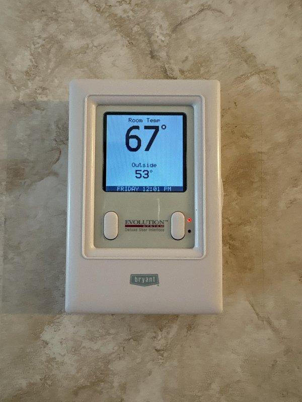 Completed annual maintenance on air conditioning system. Performed comprehensive inspection of all components, verified proper operation of Bryant Evolution heat pump system with Deluxe User Interface thermostat, confirmed system settings and temperature controls functioning correctly at 67° room temperature with heat point set to 65° in hold mode.