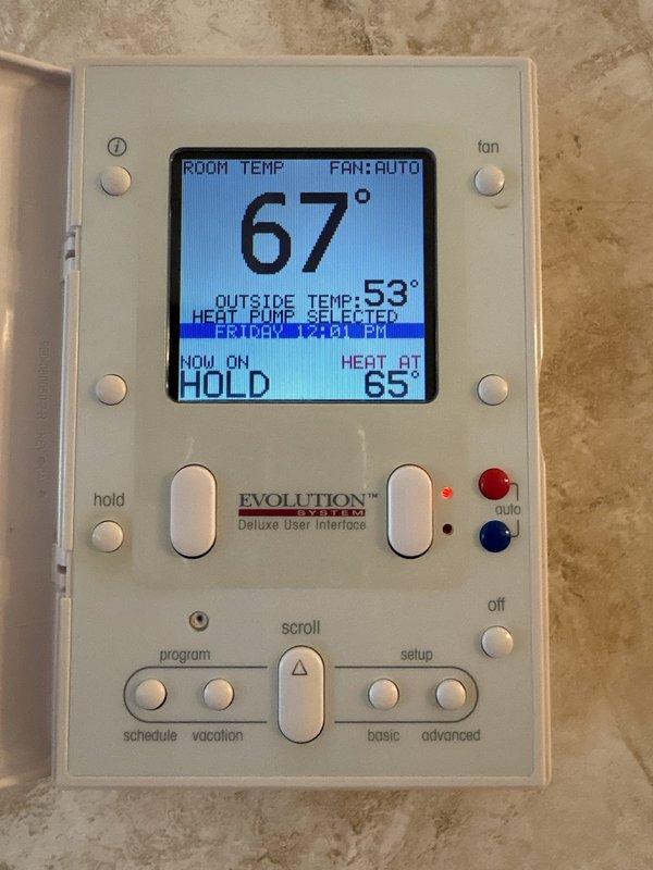 Completed annual maintenance on air conditioning system. Performed comprehensive inspection of all components, verified proper operation of Bryant Evolution heat pump system with Deluxe User Interface thermostat, confirmed system settings and temperature controls functioning correctly at 67° room temperature with heat point set to 65° in hold mode.