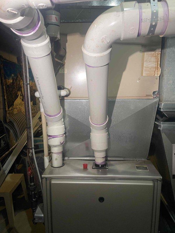 Conducted on-site evaluation of 15-year-old furnace and air conditioning system located in basement for replacement estimate. Both units currently operational but nearing end of expected service life. Assessed existing HVAC infrastructure including furnace with PVC venting system, ductwork configuration, and thermostat controls to determine replacement specifications and compatibility requirements for new equipment installation.