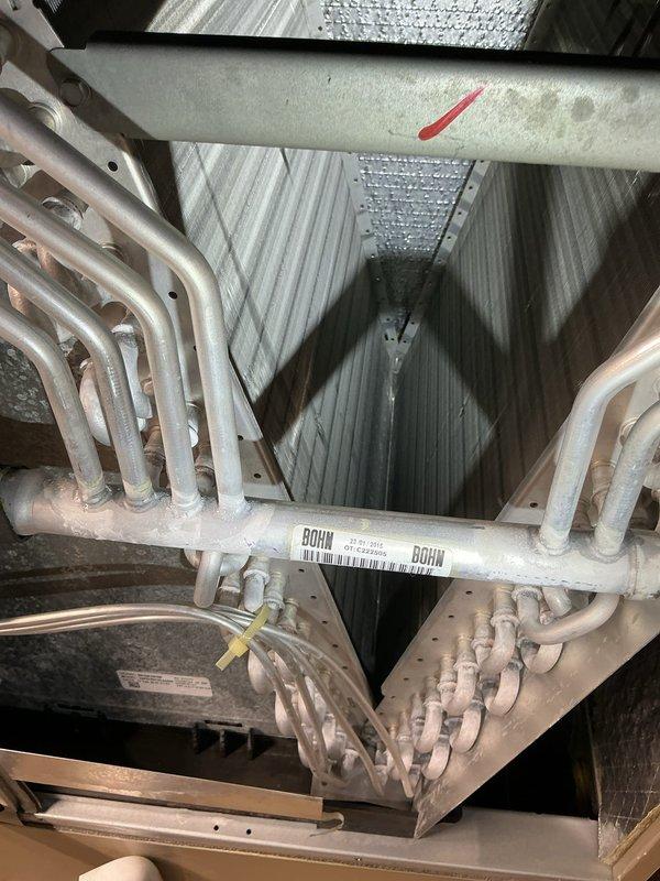 Completed annual preventive maintenance on air handler unit as part of recurring Air Care Cooling service agreement. Performed comprehensive inspection of evaporator coil assembly, which showed clean condition with no debris accumulation or signs of corrosion on the serpentine copper tubing. Verified proper coil configuration and mounting integrity within the cabinet. Inspected condensate drain system including PVC trap assembly for proper operation and confirmed clear drainage pathway with no blockages present. Examined refrigerant line insulation on suction line, noting red wrap material intact and properly sealed. Checked air handler cabinet for structural integrity, verified all access panels secure, and confirmed unit cleanliness throughout interior components. All equipment operating within normal parameters with no deficiencies noted requiring immediate attention.
