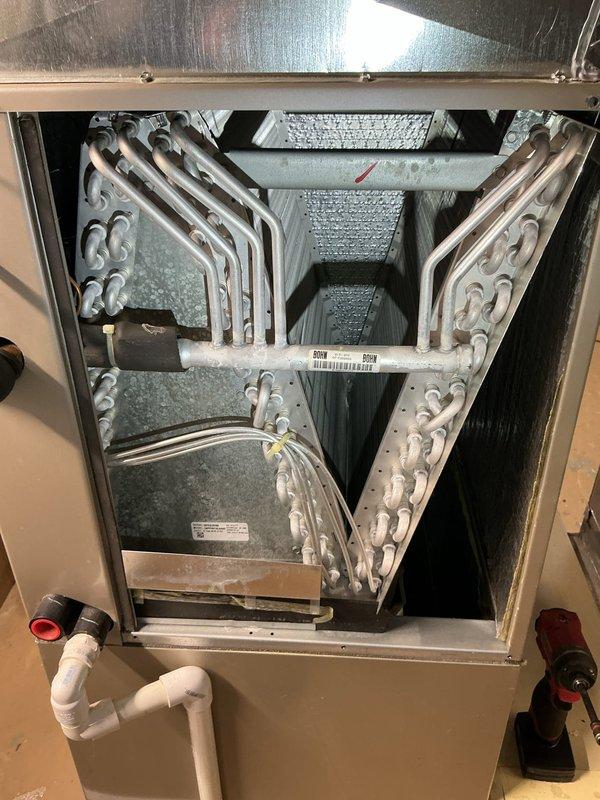 Completed annual preventive maintenance on air handler unit as part of recurring Air Care Cooling service agreement. Performed comprehensive inspection of evaporator coil assembly, which showed clean condition with no debris accumulation or signs of corrosion on the serpentine copper tubing. Verified proper coil configuration and mounting integrity within the cabinet. Inspected condensate drain system including PVC trap assembly for proper operation and confirmed clear drainage pathway with no blockages present. Examined refrigerant line insulation on suction line, noting red wrap material intact and properly sealed. Checked air handler cabinet for structural integrity, verified all access panels secure, and confirmed unit cleanliness throughout interior components. All equipment operating within normal parameters with no deficiencies noted requiring immediate attention.