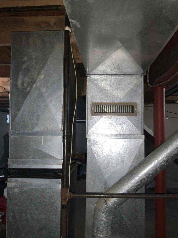 Conducted site assessment for new air conditioning system installation in residential property with no existing A/C equipment. Evaluated basement utility area to determine optimal placement and configuration for new system components, reviewing existing ductwork infrastructure, available space near water heater and support columns, and electrical service capacity. Documented current HVAC setup including furnace unit and supply duct layout to provide accurate equipment sizing recommendations and installation estimate.