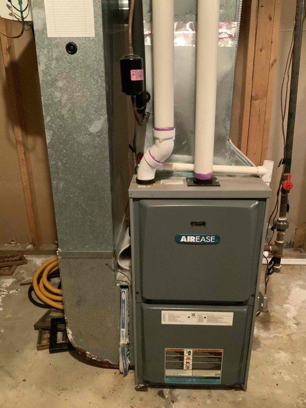 Completed HVAC estimate for replacement of sixteen-year-old air conditioning system in residential basement installation. Assessed existing AirEase furnace unit with connected air handler, evaluated ductwork configuration, PVC venting system with intake and exhaust pipes, and associated copper refrigerant lines. Documented current system specifications, measurements, and equipment layout including filter/drier components and electrical connections to provide comprehensive replacement quote for expedited installation as requested.