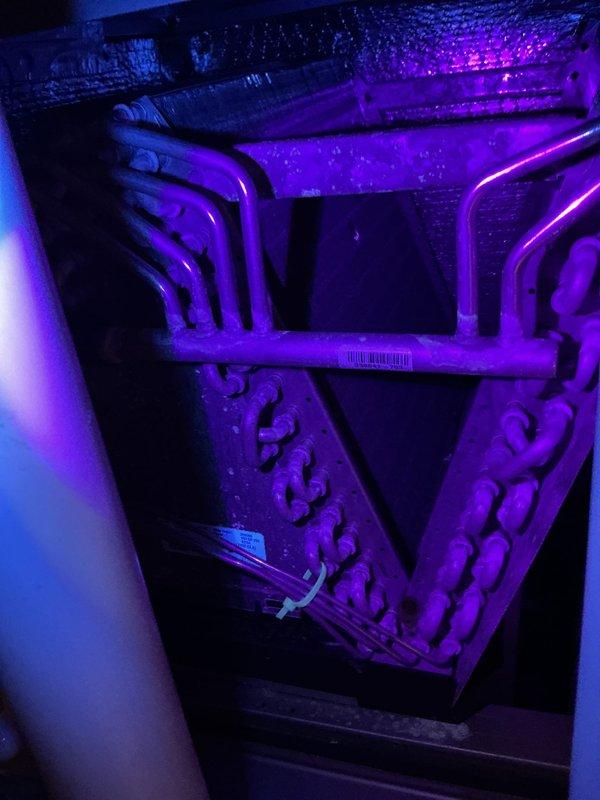 Completed comprehensive air conditioning maintenance inspection on residential HVAC system. Accessed air handler unit and thoroughly examined evaporator coil, which showed normal condensation accumulation indicating proper cooling operation. Inspected refrigerant line connections, heat exchanger coils, and serpentine tubing configuration—all components found to be in serviceable condition with typical dust accumulation for normal operation. Verified ductwork connections and insulation integrity throughout accessible areas. System operating within normal parameters at time of inspection.