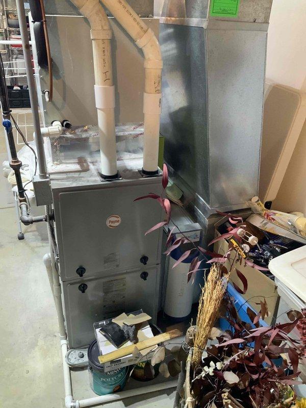 Completed full HVAC system estimate for furnace and air conditioning replacement under promotional offer. Evaluated existing basement installation including gray metal furnace unit with vertical ductwork, PVC condensate drainage lines, and associated cooling equipment. Assessed electrical infrastructure including Generac backup power system and electrical panel configuration to ensure compatibility with proposed equipment upgrades.