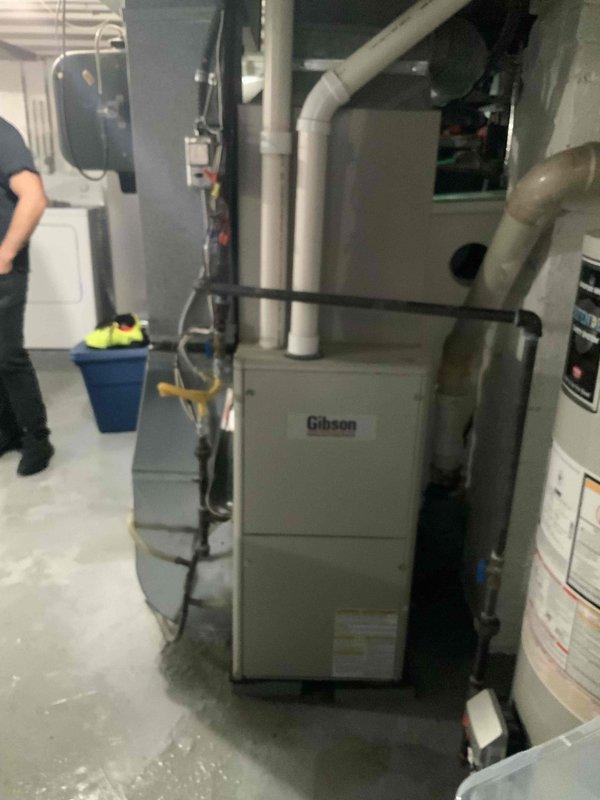 Conducted on-site evaluation of 7-year-old residential air conditioning system that is not operating efficiently and was previously serviced with recommendation for replacement. Assessed existing Gibson HVAC equipment installation in basement utility room and inspected outdoor unit location adjacent to deck area. Prepared comprehensive replacement estimate for air conditioning system only, documenting current equipment condition and site specifications for proposed installation.