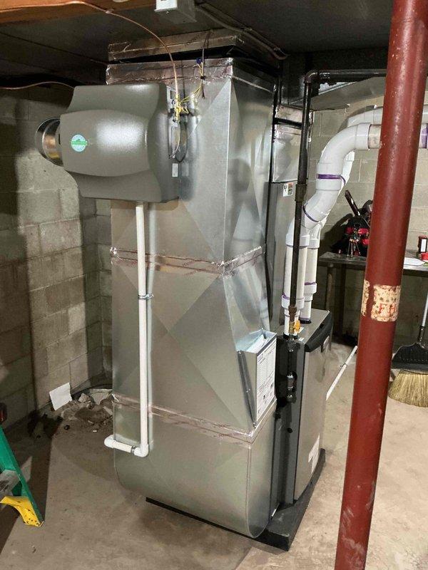 Completed full HVAC system installation including 90,000 BTU furnace, 3-ton air conditioning unit with left-side configuration, humidifier, and hot water heater in basement mechanical room. All equipment installed per manufacturer specifications with proper venting, refrigerant line connections, electrical disconnects, and PLC piping. System tested, operational, and ready for service with all required permits obtained.