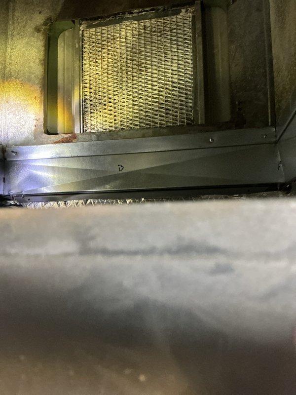 Completed annual preventative maintenance on residential HVAC system. Performed comprehensive inspection of air handler unit, including examination of evaporator coil and filter assembly. Coil showed normal wear patterns consistent with system age, with mesh honeycomb structure intact and functioning properly. Verified condensate drainage system and collection tray for proper operation. Documented equipment specifications and maintenance history via manufacturer labels and service stickers. System operating within normal parameters upon completion of inspection.