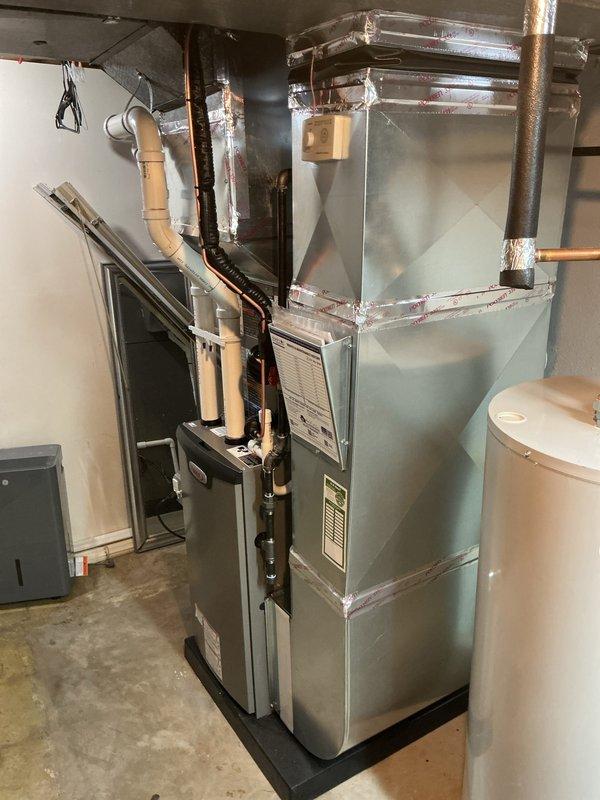 Completed full HVAC system installation in residential basement utility area, including 70,000 BTU furnace with rear-positioned 2-ton air conditioning unit. Installed complete ductwork system with galvanized metal air handling components, integrated humidifier unit, and established all necessary condensate drainage lines using PVC piping. Connected copper refrigerant lines, installed flexible corrugated tubing for system connections, and completed all electrical reconnections to ensure proper system operation. All mechanical permits were obtained prior to installation, and system was fully commissioned and tested for proper airflow, heating, and cooling functionality.