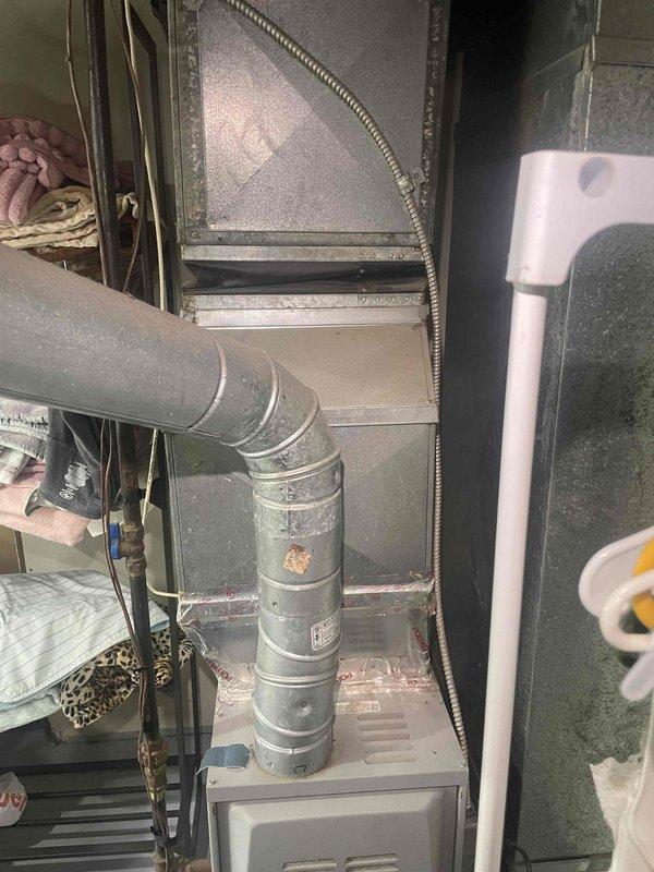 Conducted on-site evaluation of existing HVAC system located in basement utility closet for equipment replacement estimate. Air conditioning unit confirmed non-operational while furnace remains functional. Documented current system configuration including metal ductwork, flexible ducting connections, and air handler installation within confined mechanical space. Assessed existing infrastructure, clearances, and installation access for proposed furnace and air conditioning replacement equipment.