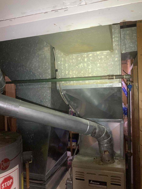 Provided comprehensive estimate for complete furnace and air conditioning system replacement in basement location. Existing 30-year-old heating system currently operational but at end of service life with no existing air conditioning present. Assessed electrical panel capacity, existing ductwork configuration, and current Amana furnace installation to determine equipment specifications and installation requirements for new HVAC system.
