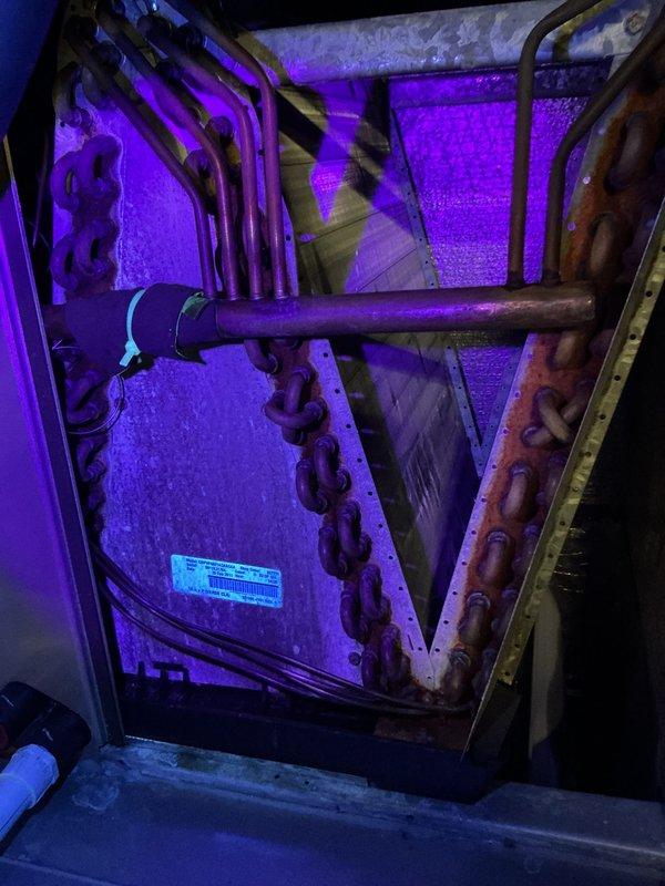 Completed annual HVAC maintenance on air handler system. Performed comprehensive inspection of unit including heat exchanger coils, refrigerant lines, and condensate management components. Noted moderate oxidation on copper refrigerant piping and significant rust/corrosion on unit frame and mounting hardware, typical of age and environmental exposure. Inspected evaporator coil assembly and verified all mechanical connections secure. Checked condensate drain system for proper operation. Documented equipment condition with photos showing foil-backed insulation intact and unit operational. System running within normal parameters at time of service. Scheduled follow-up appointment for filter and pad replacement.