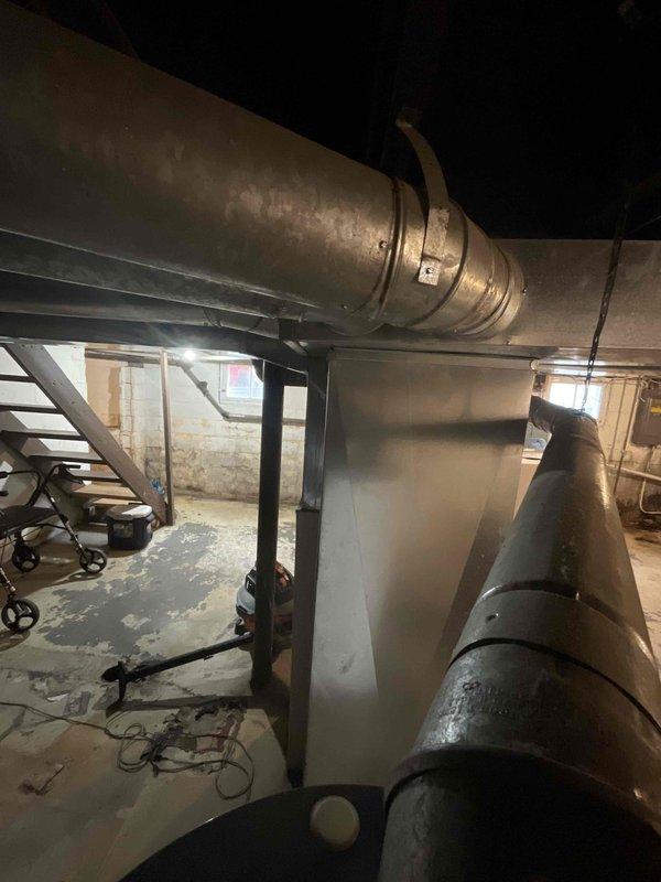 Conducted on-site evaluation for complete HVAC system replacement in residential property with 20-year-old furnace requiring replacement and new central air conditioning installation where no AC system previously existed. Assessed existing basement mechanical room infrastructure, including current ductwork configuration, electrical service availability, structural support requirements, and optimal equipment placement for new furnace and air conditioning condenser unit. Documented existing conditions through photographic records showing aged horizontal duct runs, concrete floor space for equipment installation, water heater positioning, and available clearances for new system components. Provided comprehensive replacement estimate covering removal of existing furnace, installation of new high-efficiency heating system, complete central air conditioning system integration with new outdoor condenser unit, necessary electrical upgrades, refrigerant line installation, thermostat replacement