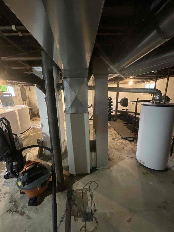 Conducted on-site evaluation for complete HVAC system replacement in residential property with 20-year-old furnace requiring replacement and new central air conditioning installation where no AC system previously existed. Assessed existing basement mechanical room infrastructure, including current ductwork configuration, electrical service availability, structural support requirements, and optimal equipment placement for new furnace and air conditioning condenser unit. Documented existing conditions through photographic records showing aged horizontal duct runs, concrete floor space for equipment installation, water heater positioning, and available clearances for new system components. Provided comprehensive replacement estimate covering removal of existing furnace, installation of new high-efficiency heating system, complete central air conditioning system integration with new outdoor condenser unit, necessary electrical upgrades, refrigerant line installation, thermostat replacement