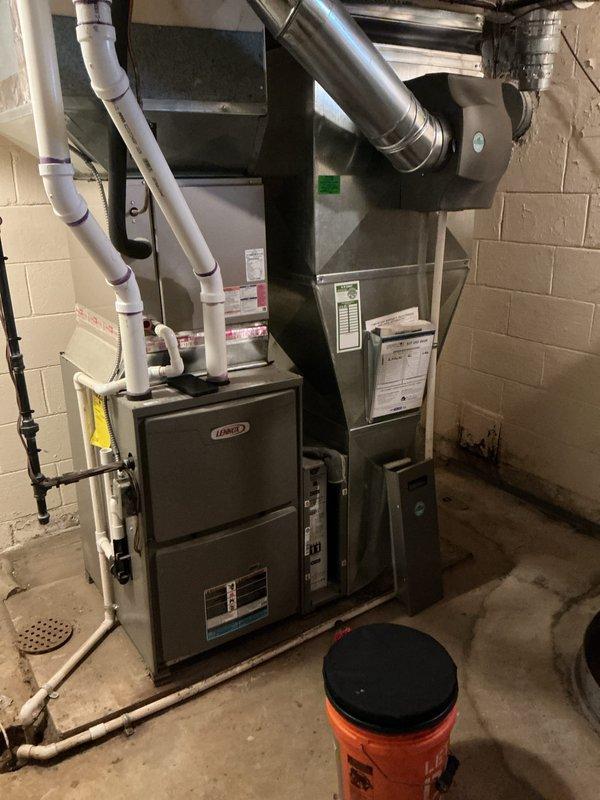 Completed annual cooling maintenance on residential HVAC system with dual Lennox furnace configuration and A-frame evaporator coil assembly. Inspected equipment operation, verified proper airflow through coil fins, checked condensate drain system with PVC piping, and documented system condition with photographs. All components found operating within normal parameters; no repairs required at this time.