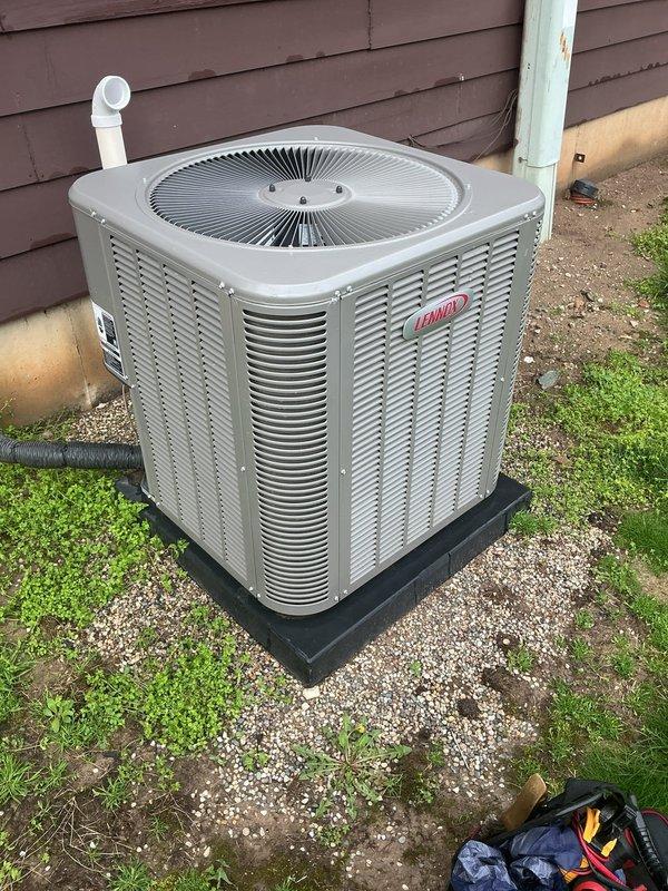 Completed comprehensive tune-up on 5-year-old Lennox air conditioning condenser unit located on exterior pad with proper clearances. Performed full system inspection including refrigerant level check, electrical connections, capacitor testing, contactor evaluation, and condenser coil cleaning. Unit operating within normal parameters with no deficiencies noted; all components functioning properly and system ready for cooling season.