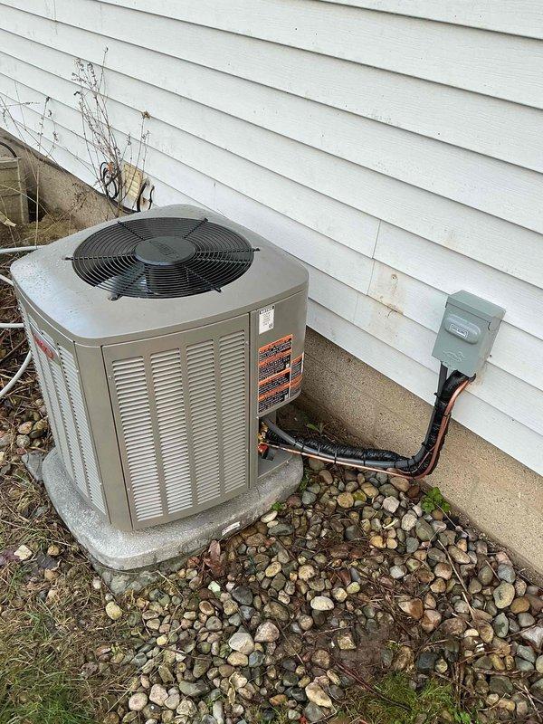 Completed full HVAC system installation including 70,000 BTU furnace, 2-ton air conditioning unit, and hot water heater replacement. Installed new furnace in basement with proper PVC venting configuration, black flexible ductwork connections, and all required piping with insulated joints. Positioned outdoor condenser unit on concrete pad with electrical disconnect box, conduit runs, and proper clearances from structure. All equipment installed per manufacturer specifications and local mechanical permit requirements, system tested and operational.