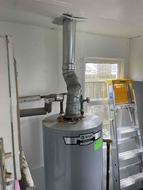 Conducted assessment and consultation for furnace relocation from bathroom to alternative location. Evaluated 10-year-old existing furnace system and provided replacement options to homeowner. Documented current installation showing furnace positioned in bathroom area adjacent to A.O. Smith water heater with existing venting configuration running through ceiling. Reviewed space constraints, venting requirements, and discussed optimal placement solutions for improved accessibility and code compliance.