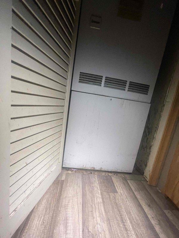 Conducted comprehensive site evaluation for full HVAC system replacement estimate at residential property with 16-year-old air conditioning system that experienced compressor failure several years ago. Assessed existing return air grille locations in stairwell area and utility closet, documented current ventilation configuration including louvered access panels and ductwork placement, and photographed installation areas to determine equipment specifications and replacement requirements for new central air conditioning unit.