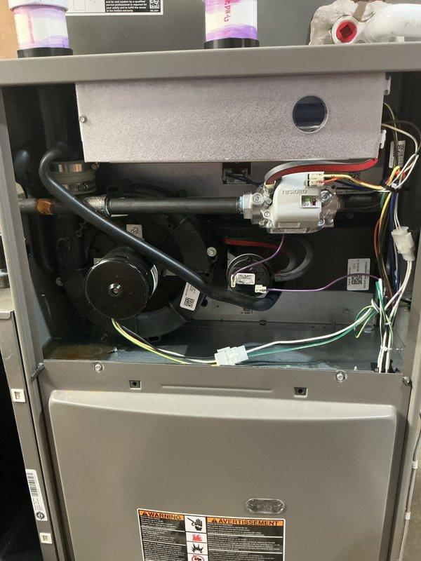 Completed scheduled AHC maintenance on furnace unit, including thorough inspection of blower motor assembly, electrical connections, and control board. Verified all safety labels present and legible, confirmed proper wire routing and connections throughout heating and cooling components, and documented system condition with interior component photography showing heat exchanger, cylindrical capacitor (T351650), and all mechanical systems operating within normal parameters.