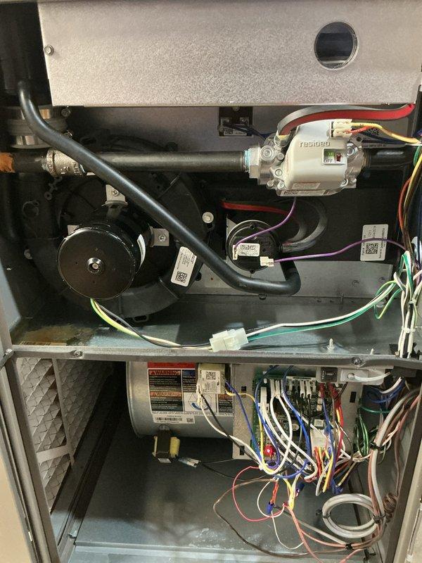 Completed scheduled AHC maintenance on furnace unit, including thorough inspection of blower motor assembly, electrical connections, and control board. Verified all safety labels present and legible, confirmed proper wire routing and connections throughout heating and cooling components, and documented system condition with interior component photography showing heat exchanger, cylindrical capacitor (T351650), and all mechanical systems operating within normal parameters.