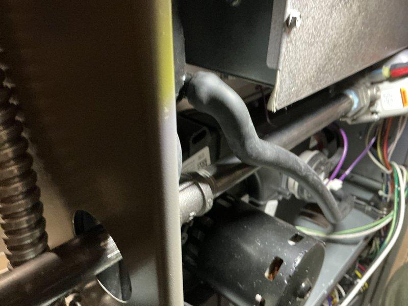 Completed annual heating and cooling maintenance inspection on HVAC system. Removed access panels to inspect blower motor assembly, capacitor, and electrical connections. Verified all wiring connections were secure, checked capacitor operation, and inspected blower motor for proper function. Documented equipment condition with photographs showing internal components including motor assembly, ductwork connections, and control wiring. All components found operating within normal parameters with no immediate service needs identified.