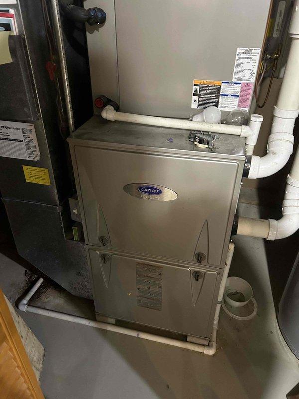 Responded to service call for Carrier furnace displaying ECM blower motor failure error code. Upon inspection of the 10+ year old unit located in basement, diagnosed failed electronically commutated motor preventing proper airflow and system operation. Replaced defective ECM blower motor assembly with OEM replacement unit, verified proper electrical connections, and tested furnace through complete heating cycle to confirm restored functionality and adequate airflow throughout the system.