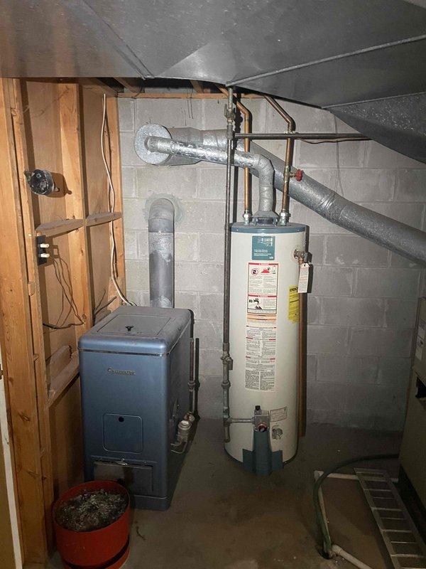 Conducted comprehensive evaluation of existing gas furnace and air conditioning system to assess repair versus replacement options. Documented current equipment configuration including furnace unit, electrical panel setup with main and secondary panels, and associated ductwork in basement mechanical room. Provided detailed assessment and replacement recommendations based on equipment condition and system performance evaluation.