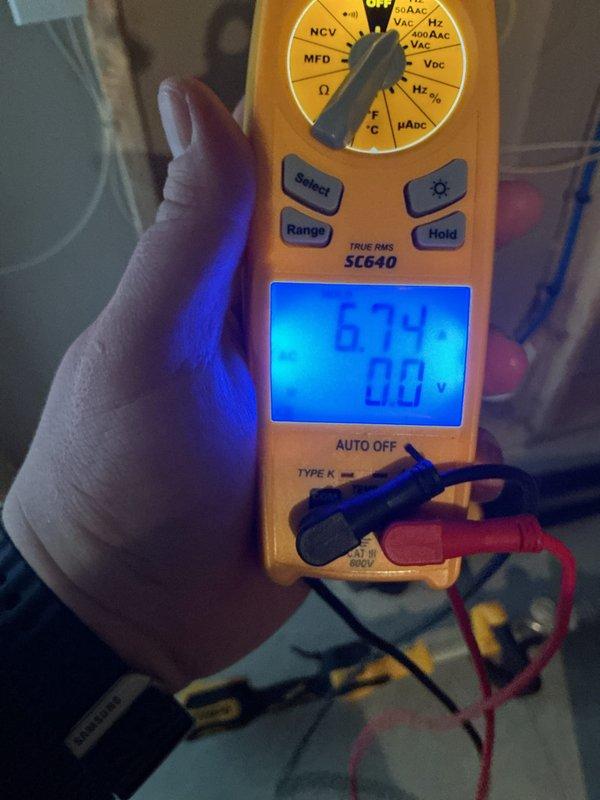 Completed annual cooling maintenance on HVAC system. Inspected refrigerant line sets, verified system electrical readings with multimeter showing 67.9 reading, and checked attic installation components including insulated copper tubing and air handler. Replaced air filter and evaporator pad as scheduled.