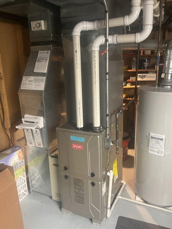 Performed annual cooling maintenance on Bryant HVAC system. Conducted comprehensive inspection of furnace and air handler assembly, documenting equipment condition through interior and exterior photography. Removed air handler access panel to inspect evaporator coil, which showed proper fin alignment and no visible debris accumulation. Verified refrigerant line connections and insulation integrity on copper tubing. Confirmed drainage pan condition and proper placement. Inspected electrical connections and wiring bundles within cabinet. Verified PVC intake and exhaust venting configuration and proper termination. System operational and ready for cooling season.