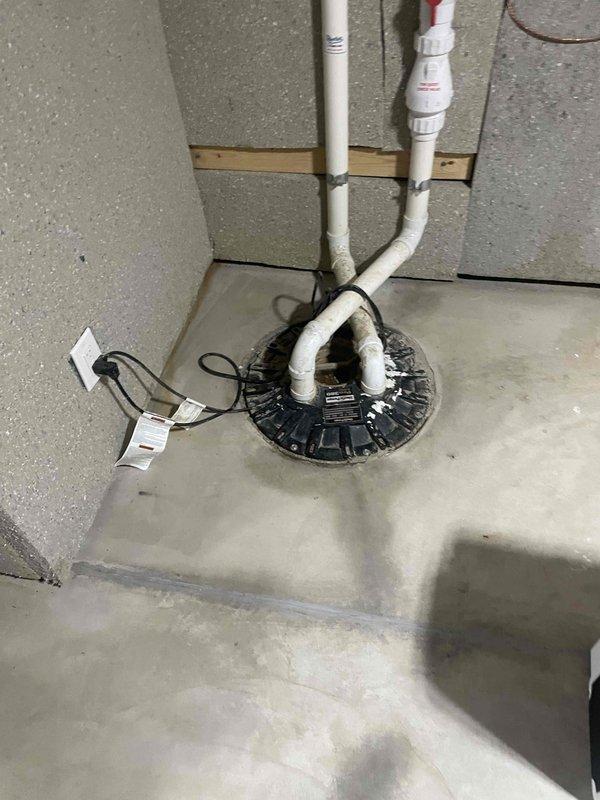 Conducted comprehensive site assessment for new Kohler whole home generator installation. Evaluated existing electrical service panel containing dual-column breaker configuration with circuits serving residential loads including HVAC systems, major appliances, and general lighting circuits. Documented panel capacity and circuit distribution to determine proper generator sizing and transfer switch requirements. Inspected basement utility area and identified suitable location for generator pad placement with consideration for drainage systems, existing sump pump installation, and PVC discharge piping. Assessed electrical service entrance and determined optimal routing for generator feeder cables and automatic transfer switch integration with existing distribution panel.