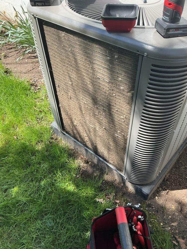Completed scheduled Air Care Cooling maintenance on outdoor HVAC system. Replaced heavily soiled and discolored air filter showing significant dust and debris accumulation. Inspected condenser unit exterior, confirmed proper fan grille condition, and verified unit positioning on concrete pad remains stable.