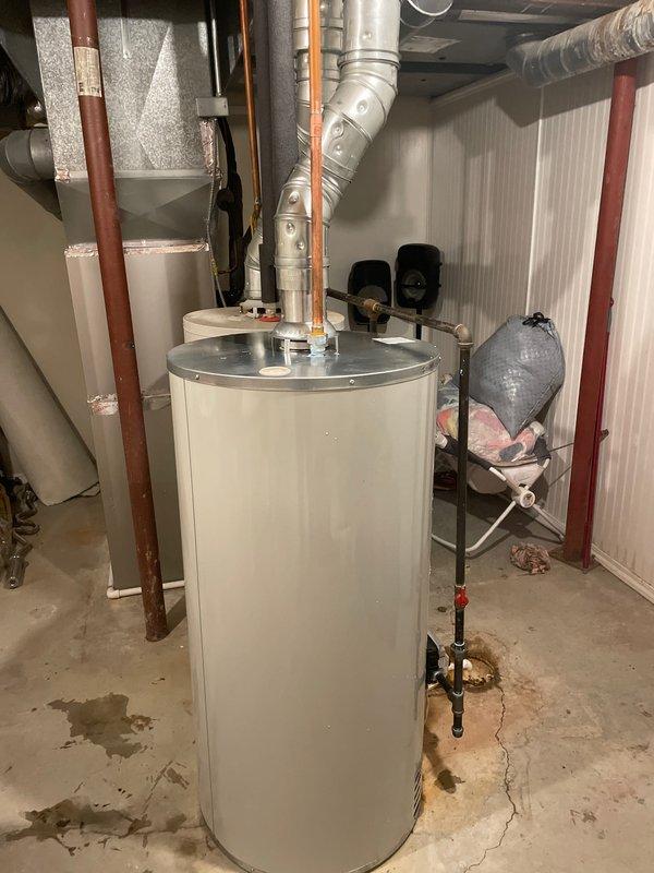 Completed installation of a 50-gallon Bradford White tanked water heater in basement utility room. Removed existing unit, installed new water heater with proper venting connections, connected copper supply and discharge lines with appropriate insulation, installed pressure relief valve with discharge piping, and verified all plumbing connections for proper operation. Work performed under valid mechanical permit, all code requirements met, and system tested successfully upon completion.