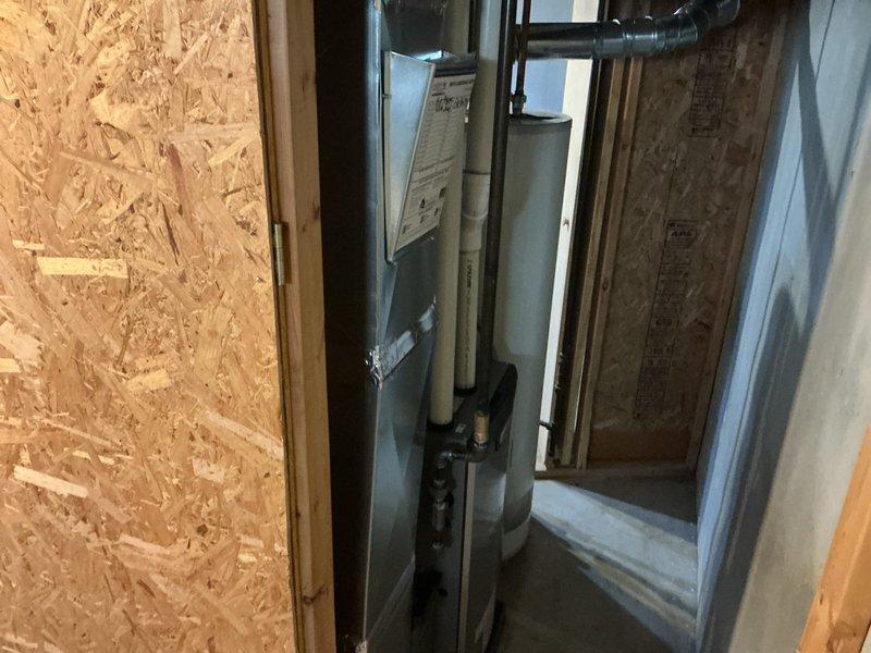 Completed full HVAC system installation including 70,000 BTU furnace with humidifier and liner, 2-ton air conditioning unit with left-side configuration, and new dedicated electrical circuit. Mechanical and electrical permits obtained prior to installation. All equipment installed in basement utility area with proper venting, ductwork connections, and electrical service established per code requirements.