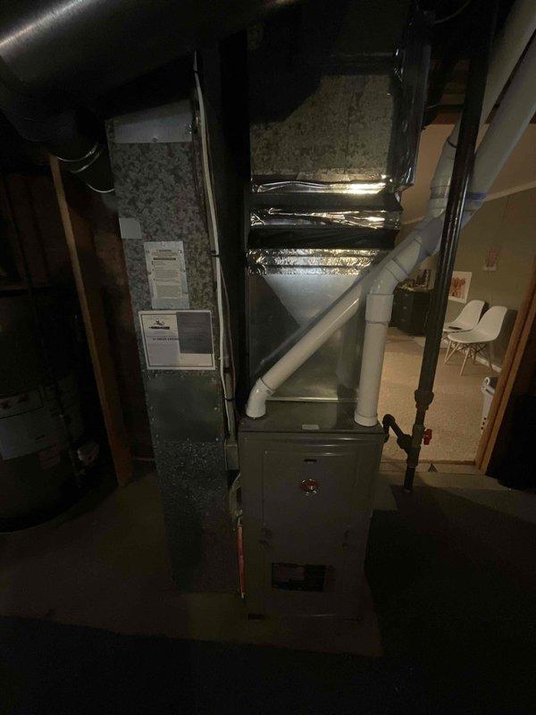 Completed air conditioning replacement estimate for a 20-year-old existing system. Inspected current HVAC equipment located in basement mechanical room, including furnace unit with PVC venting, air handler cabinet, and associated ductwork. Evaluated electrical service panel and circuit capacity for AC condenser requirements. Documented equipment specifications, existing installation configuration, and photographed current system components to provide comprehensive replacement options for aging air conditioning unit.