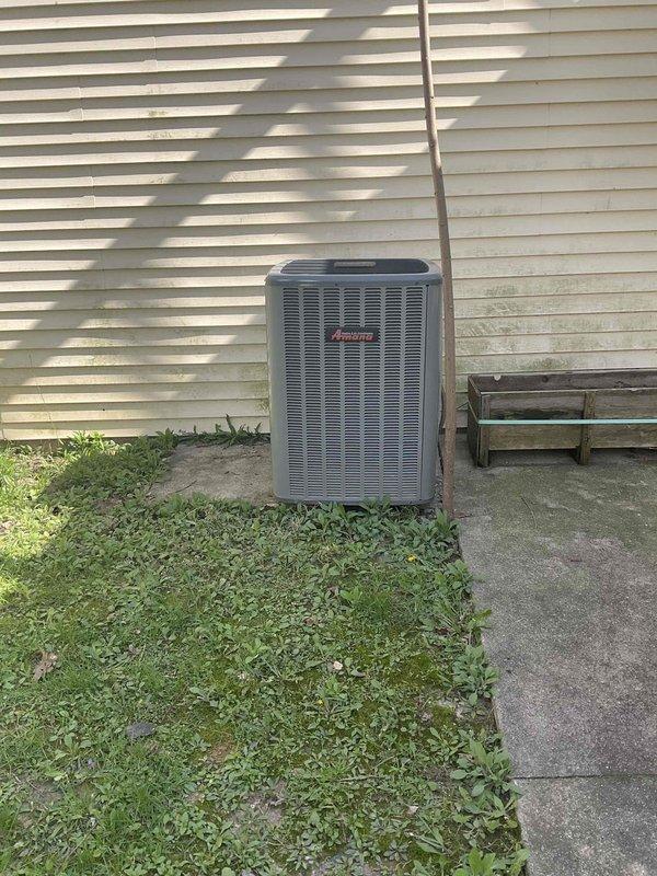 Conducted comprehensive evaluation of existing HVAC system for full replacement estimate. Assessed 33-year-old Amana air conditioning condenser unit located on exterior concrete pad and corresponding indoor air handler/furnace equipment housed in confined utility closet. Both heating and cooling components have reached end of useful service life, showing significant age-related wear and obsolescence. Documented current equipment configuration including refrigerant line routing, electrical connections, ductwork arrangement, and spatial constraints within mechanical closet. Photographed outdoor condenser positioning against building siding and indoor vertical equipment installation to determine replacement specifications and identify any installation challenges. Evaluated adequate clearances, existing concrete pad condition, and access requirements for future equipment removal and installation.